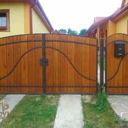 A wrought iron gate - wood - metal, harmony of materials