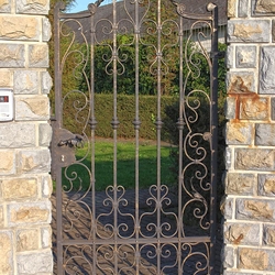 An exclusive wrought iron gate and fence in a family villa - A historical gate